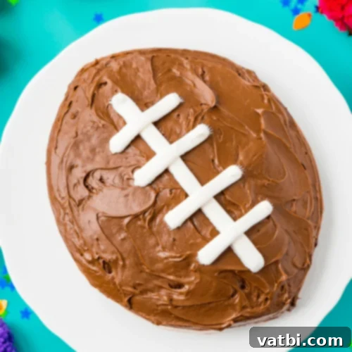 Creative Football Cake Inspiration 14 Easy football cake decorated with white laces on a brown frosting background.