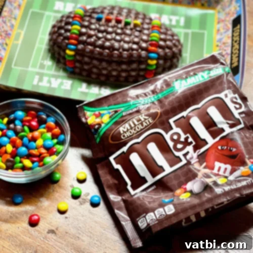 Creative Football Cake Inspiration 19 M&M Football Cake decorated with colorful candies in team colors.