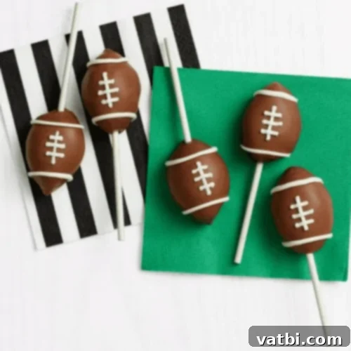 Creative Football Cake Inspiration 20 Game-Day Football Cake Pops dipped in chocolate and decorated with white icing laces.