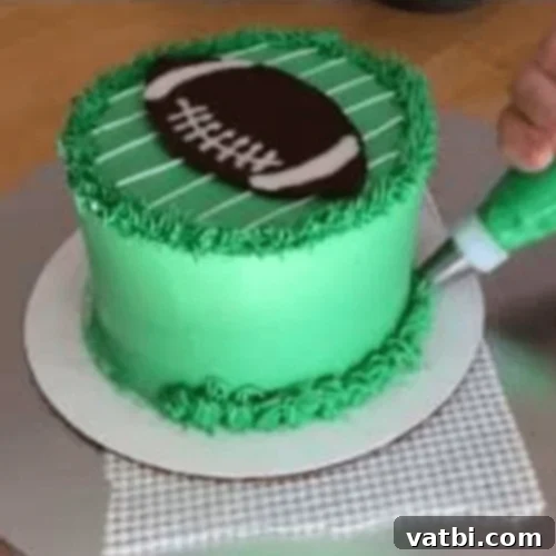 Creative Football Cake Inspiration 22 Simple football cake decorated with buttercream icing and a grass piping tip.