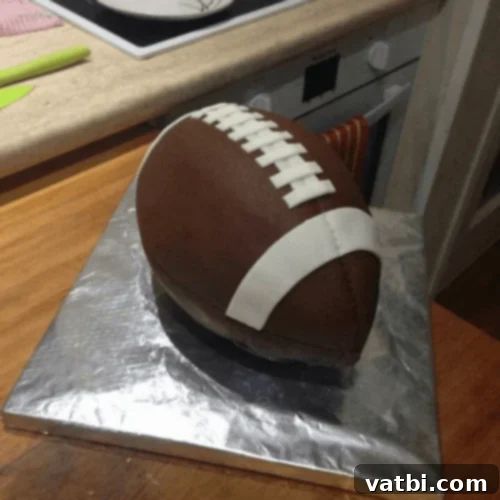Creative Football Cake Inspiration 34 Elegant football cake with smooth chocolate buttercream frosting and white laces.