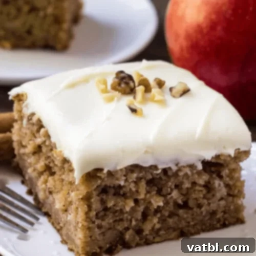 Autumn Apple Bakes 8 Apple Spice Cake with Cream Cheese Frosting, a warm and spiced fall dessert.