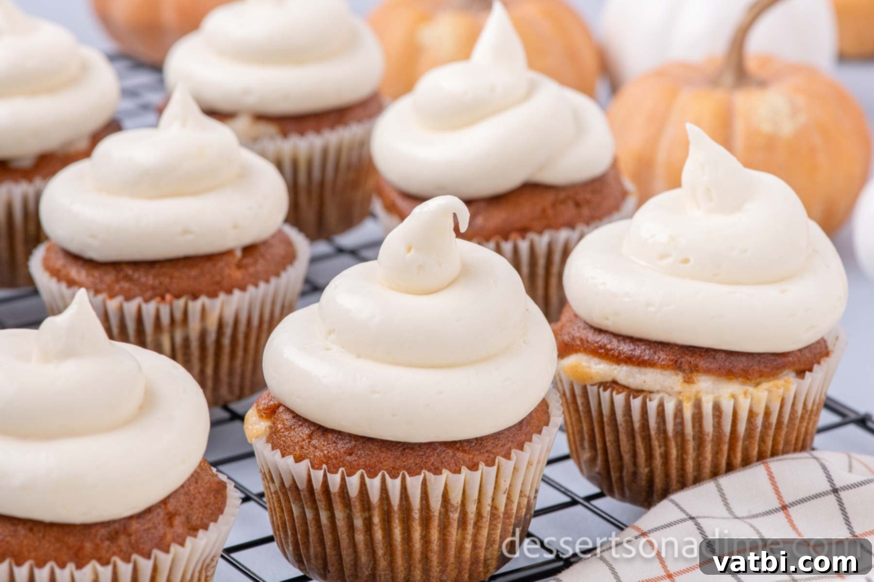 Pumpkin Cheesecake Cupcakes beautifully arranged on a wire rack, ready for serving and enjoyment.