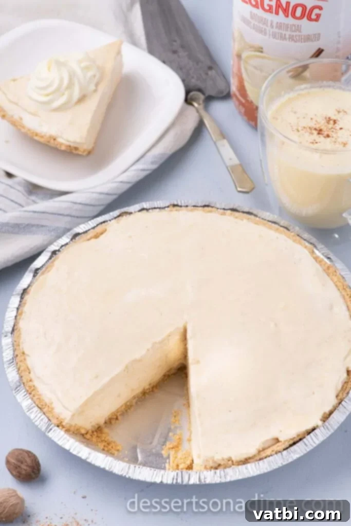 Holiday Eggnog Delight 8 A slice of creamy Eggnog Pie removed from a foil pie plate, showcasing the thick filling and golden crust.