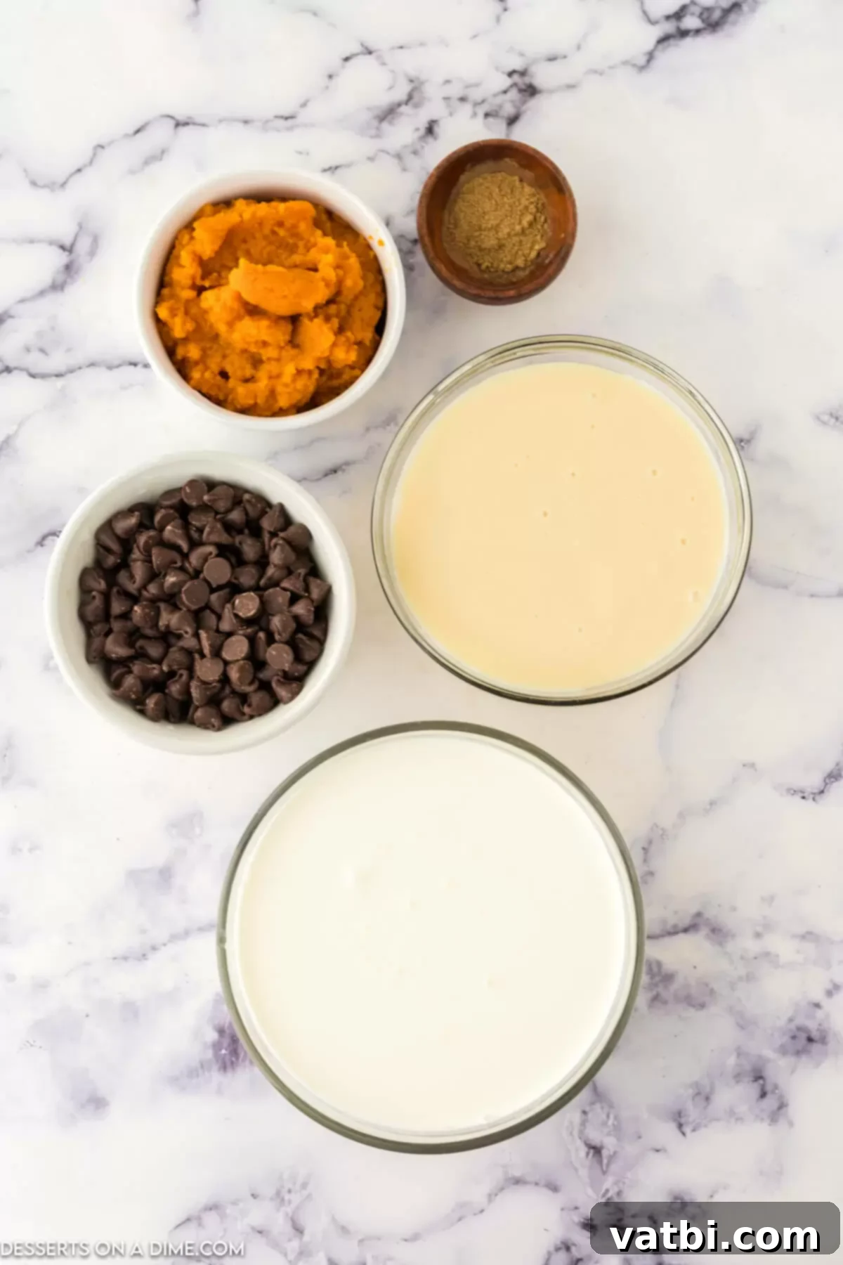 Spiced Pumpkin Chocolate Chunk Dream 3 Heavy whipping cream, sweetened condensed milk, pumpkin puree, pumpkin pie spice, and semi-sweet chocolate chips laid out as ingredients for the ice cream recipe