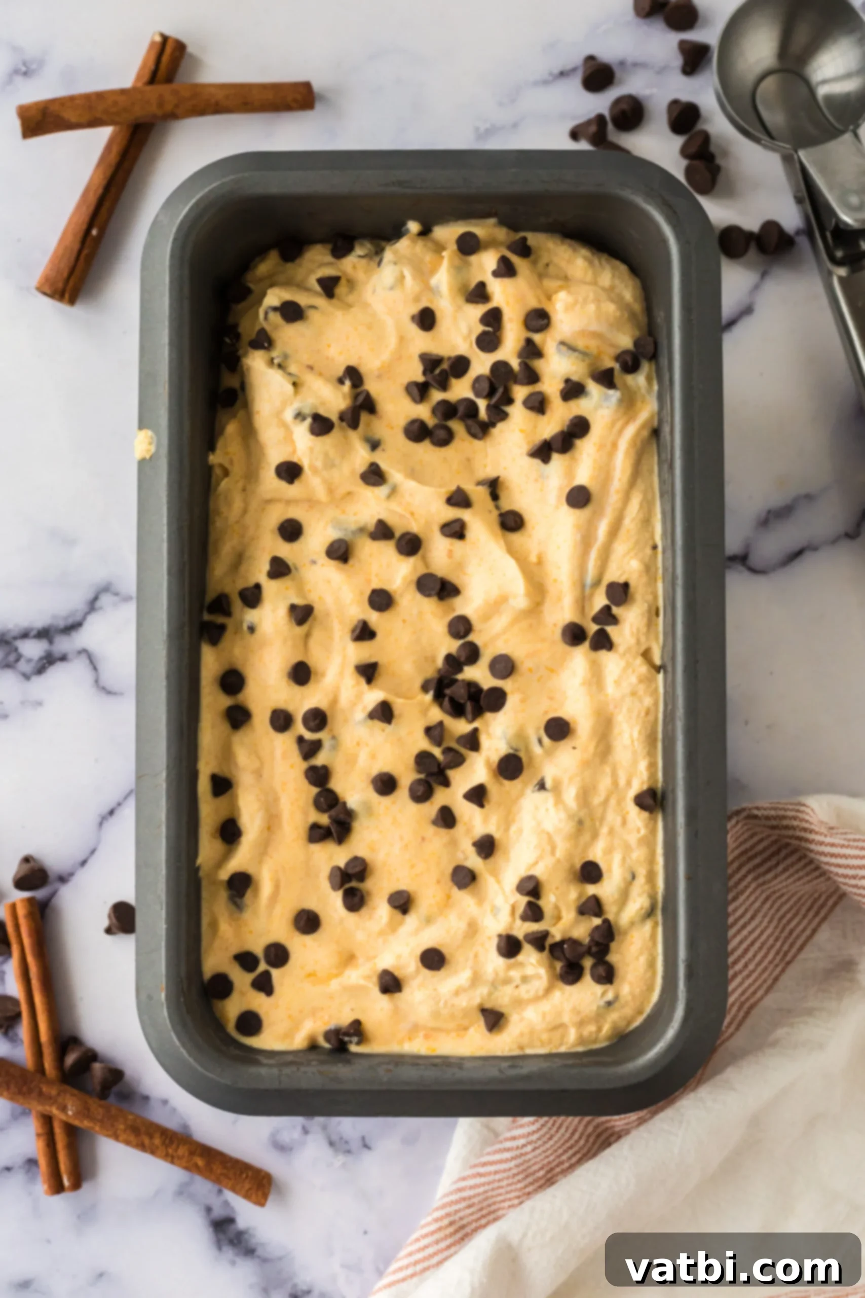 Spiced Pumpkin Chocolate Chunk Dream 7 The finished pumpkin chocolate chip ice cream mixture spread into a 9x5 inch loaf pan, ready for freezing