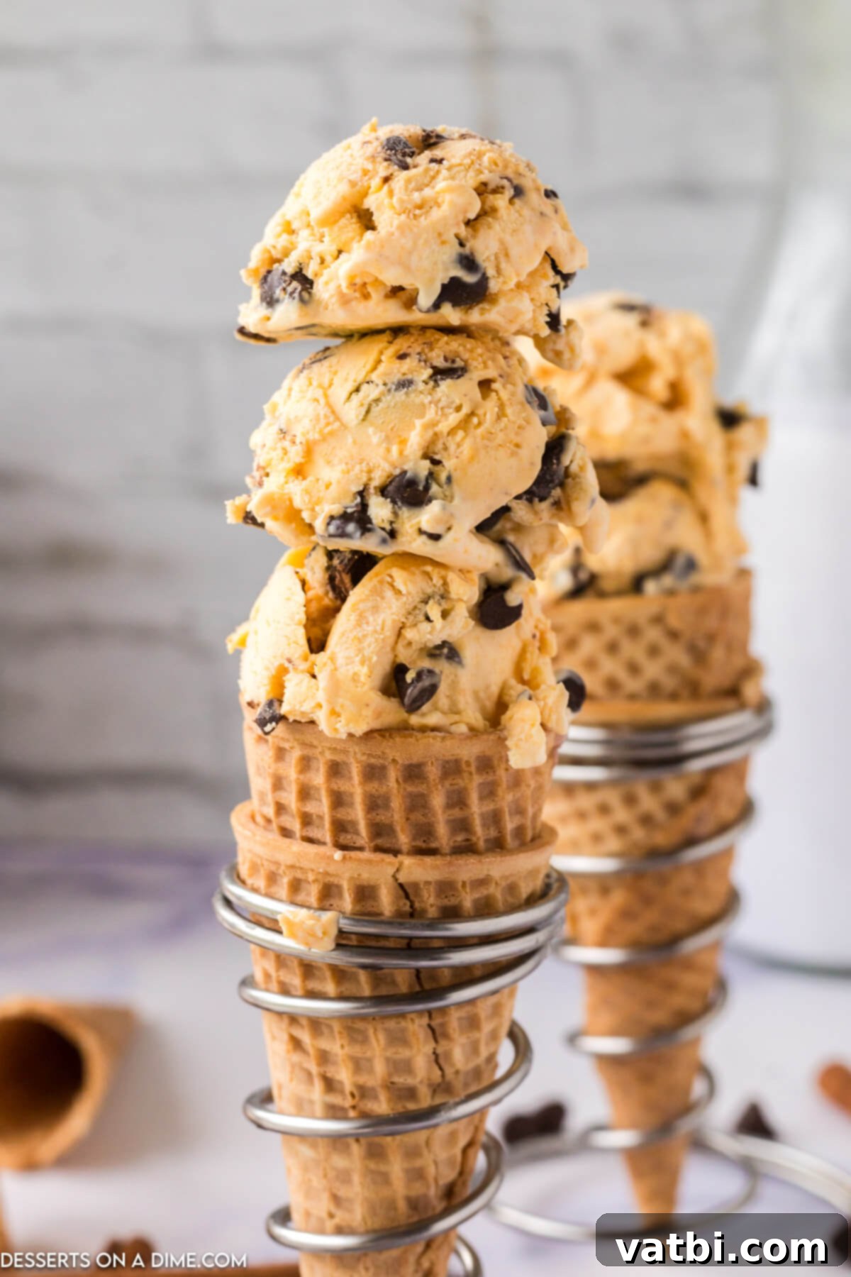 Spiced Pumpkin Chocolate Chunk Dream 9 Pumpkin Chocolate Chip Ice Cream served in a crispy waffle cone, ready to be enjoyed