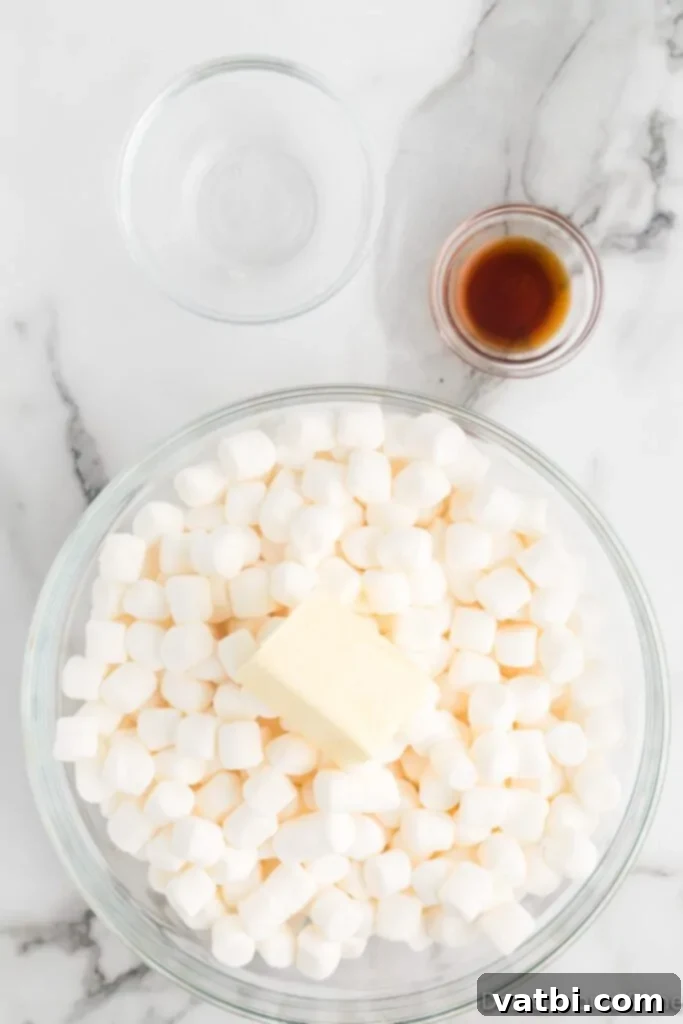 Homemade Popcorn Delight Bars 5 A microwave-safe bowl containing mini marshmallows and unsalted butter, prepped for melting into a gooey mixture.