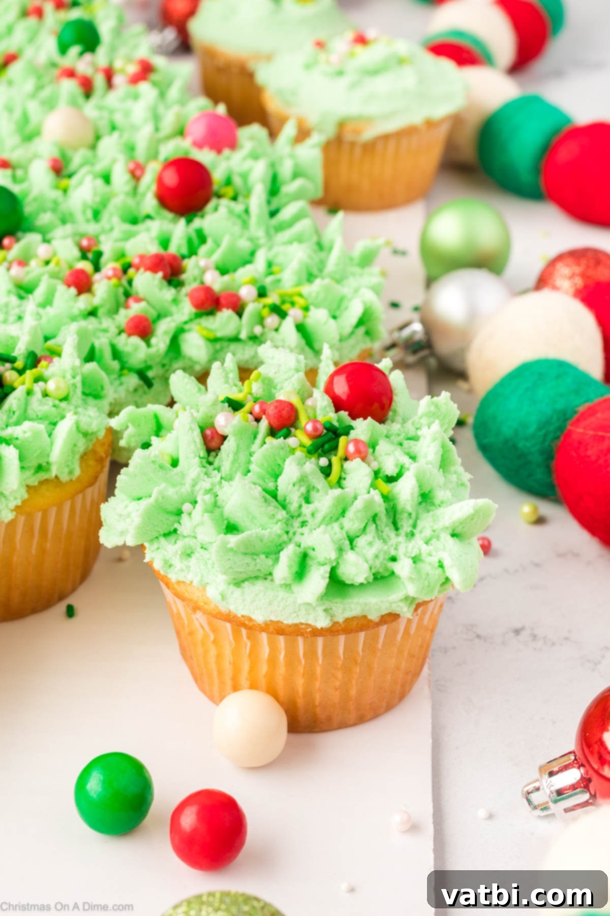 The completed Christmas Tree Cupcake Cake on a festive platter, with one cupcake already pulled away, ready for serving.