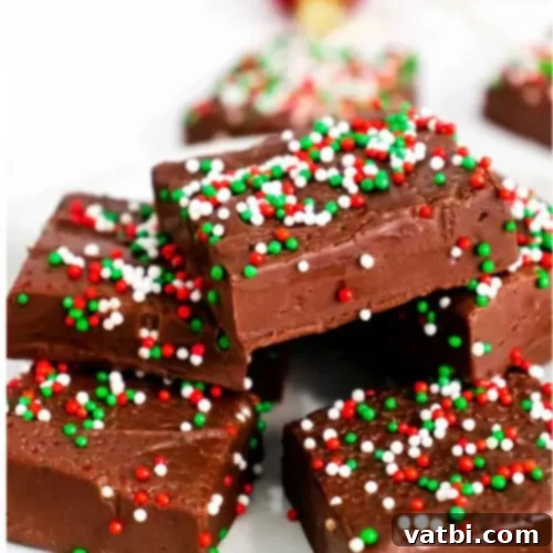 Festive Candy Treats 25 Christmas Fudge, a classic chocolate fudge that is creamy, smooth, and easy to make for holidays.