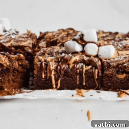 Marshmallow Fluff Delights 6 Crinkle Top Brownies topped with a layer of marshmallow fluff, showcasing the delightful crackle.