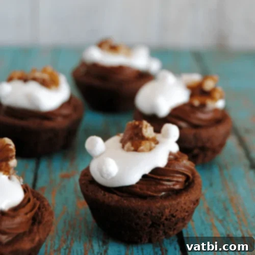 Marshmallow Fluff Delights 16 Rocky Road Brownie Bites topped with marshmallows, nuts, and chocolate drizzle.
