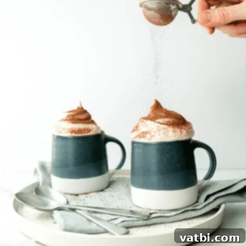 Marshmallow Fluff Delights 22 A mug of hot chocolate topped with a swirl of marshmallow fluff.