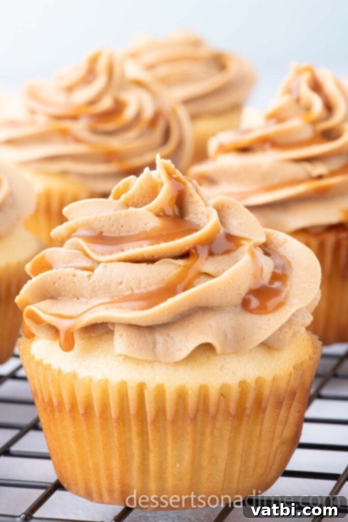 Decadent Salted Caramel Cupcakes 2 Freshly baked Salted Caramel Cupcakes cooling on a wire rack, ready for frosting.