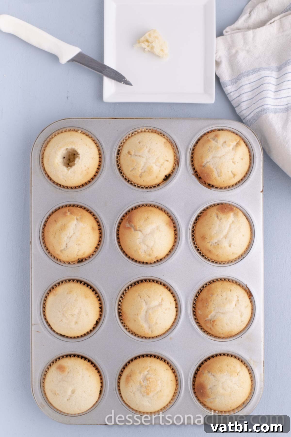 Decadent Salted Caramel Cupcakes 10 Baked cupcakes cooling in the muffin pan.