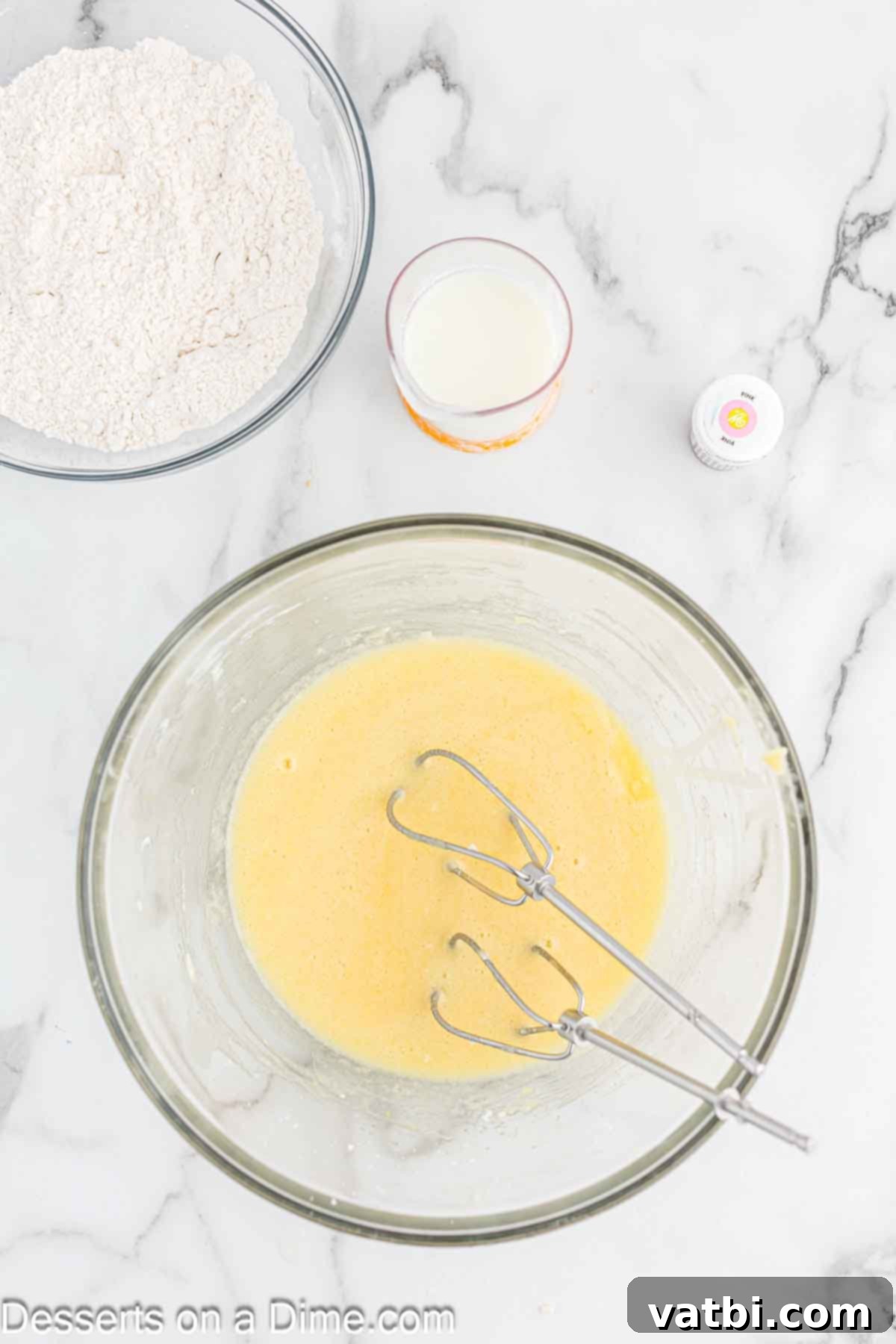 Blushing Velvet Cupcakes 5 Eggs, vegetable oil, and vanilla extract combined in a separate mixing bowl, ready to be added to the batter.
