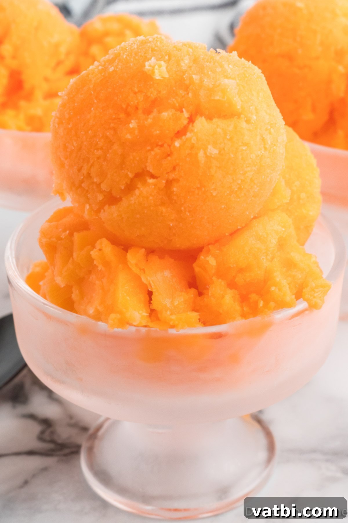 Refreshing Orange Sherbet 2 Orange Sherbet in a serving dish.