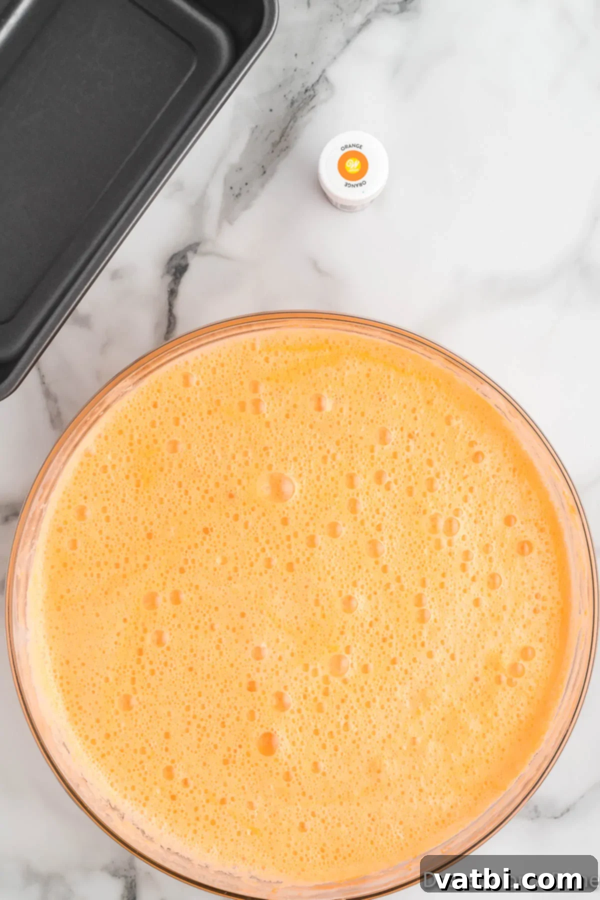 Refreshing Orange Sherbet 5 Large bowl with soda and sweetened condensed milk.