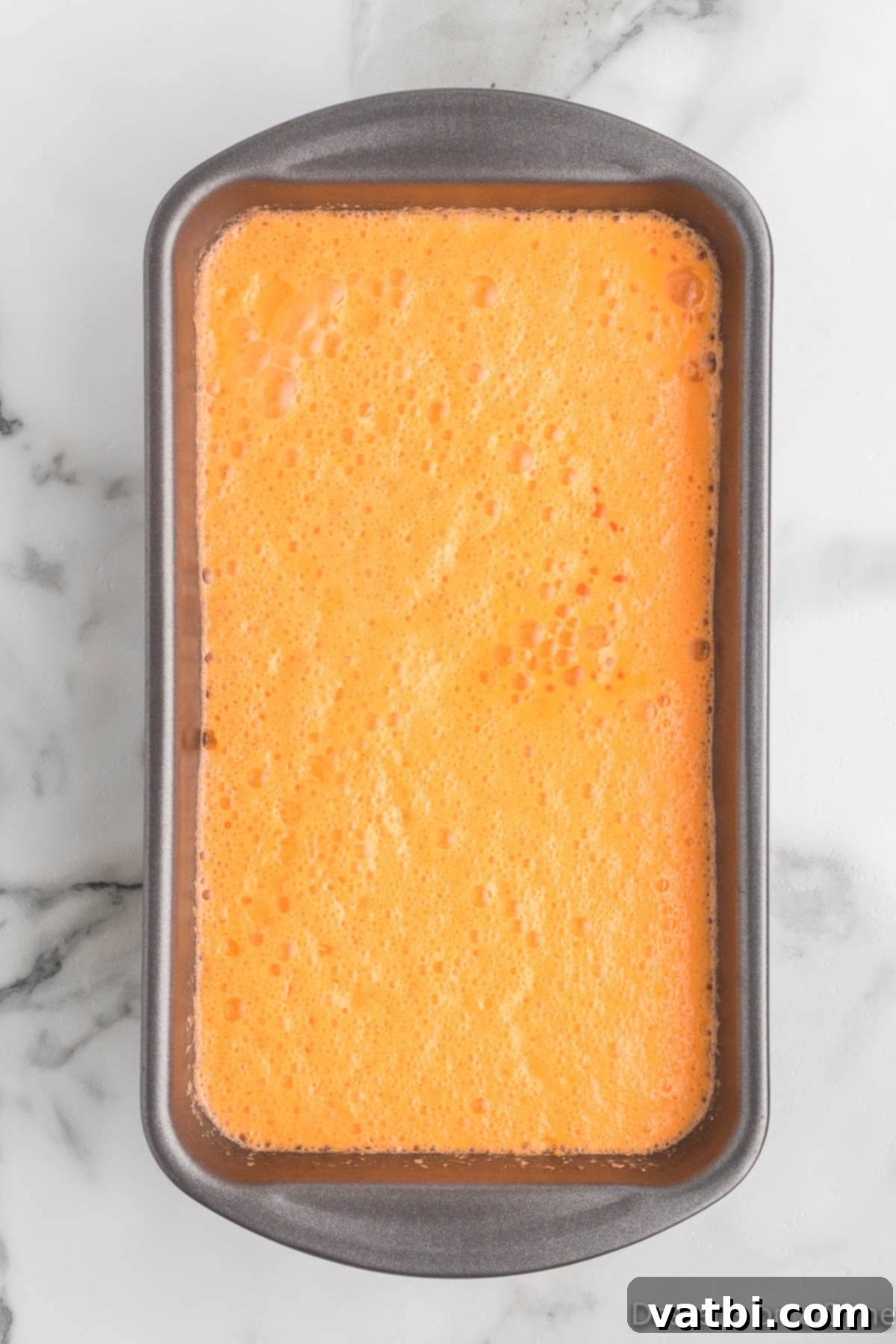 Refreshing Orange Sherbet 6 Loaf pan with mixture.