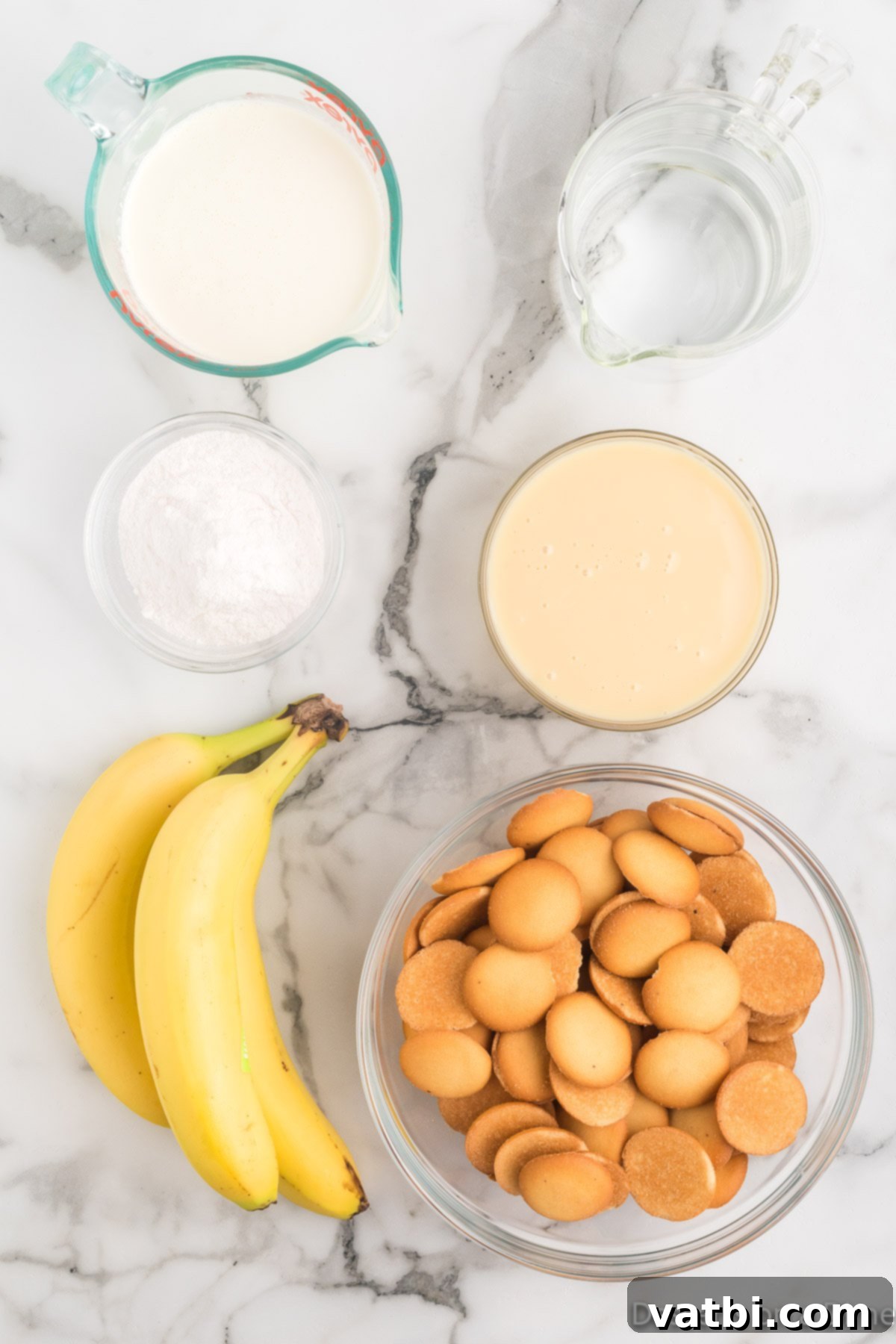 The Ultimate Magnolia Bakery Banana Pudding 3 Ingredients for Magnolia's Banana Pudding including vanilla wafers, bananas, instant pudding mix, water, and sweetened condensed milk.