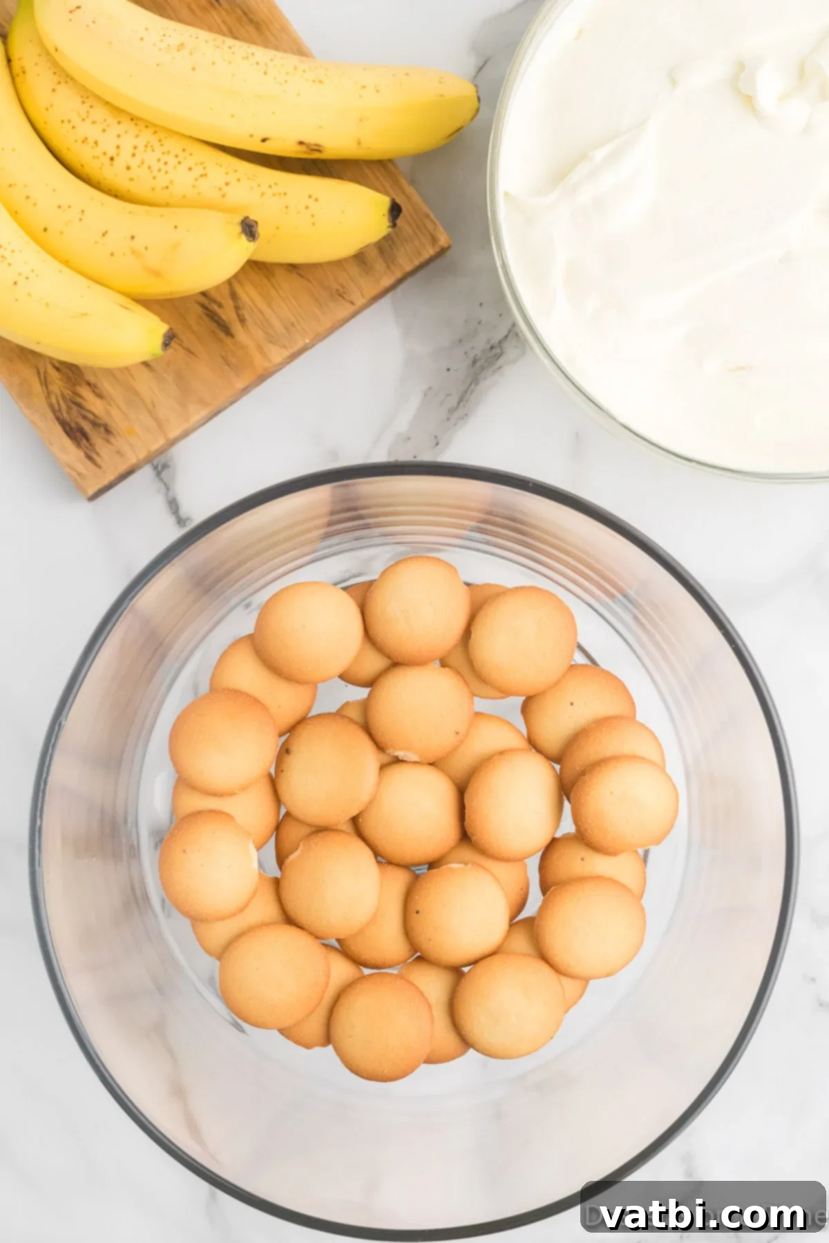 The Ultimate Magnolia Bakery Banana Pudding 7 Glass dish with a first layer of vanilla wafers.