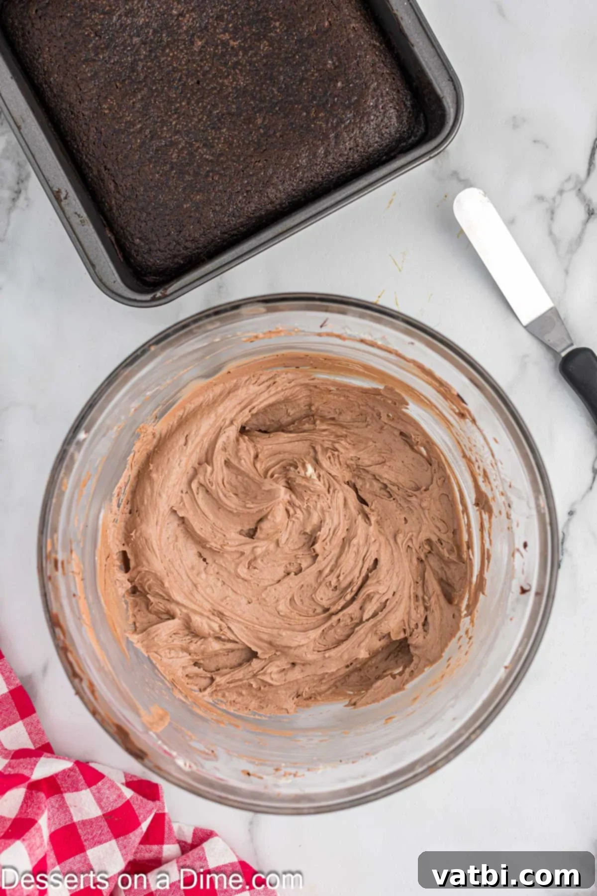 Crazy Simple Cake 11 Cooled melted chocolate being added to the butter and powdered sugar mixture in a mixing bowl.