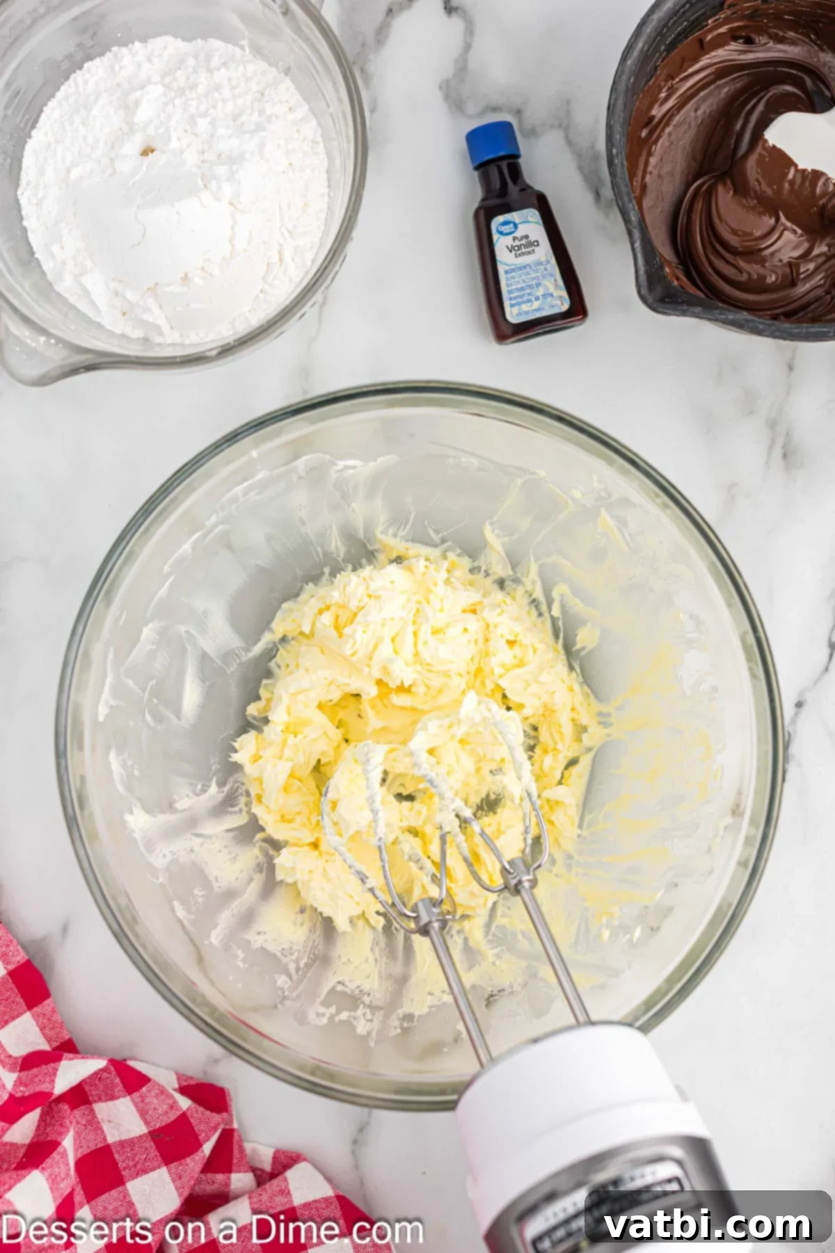 Crazy Simple Cake 9 Softened butter being creamed in a mixing bowl with an electric mixer.