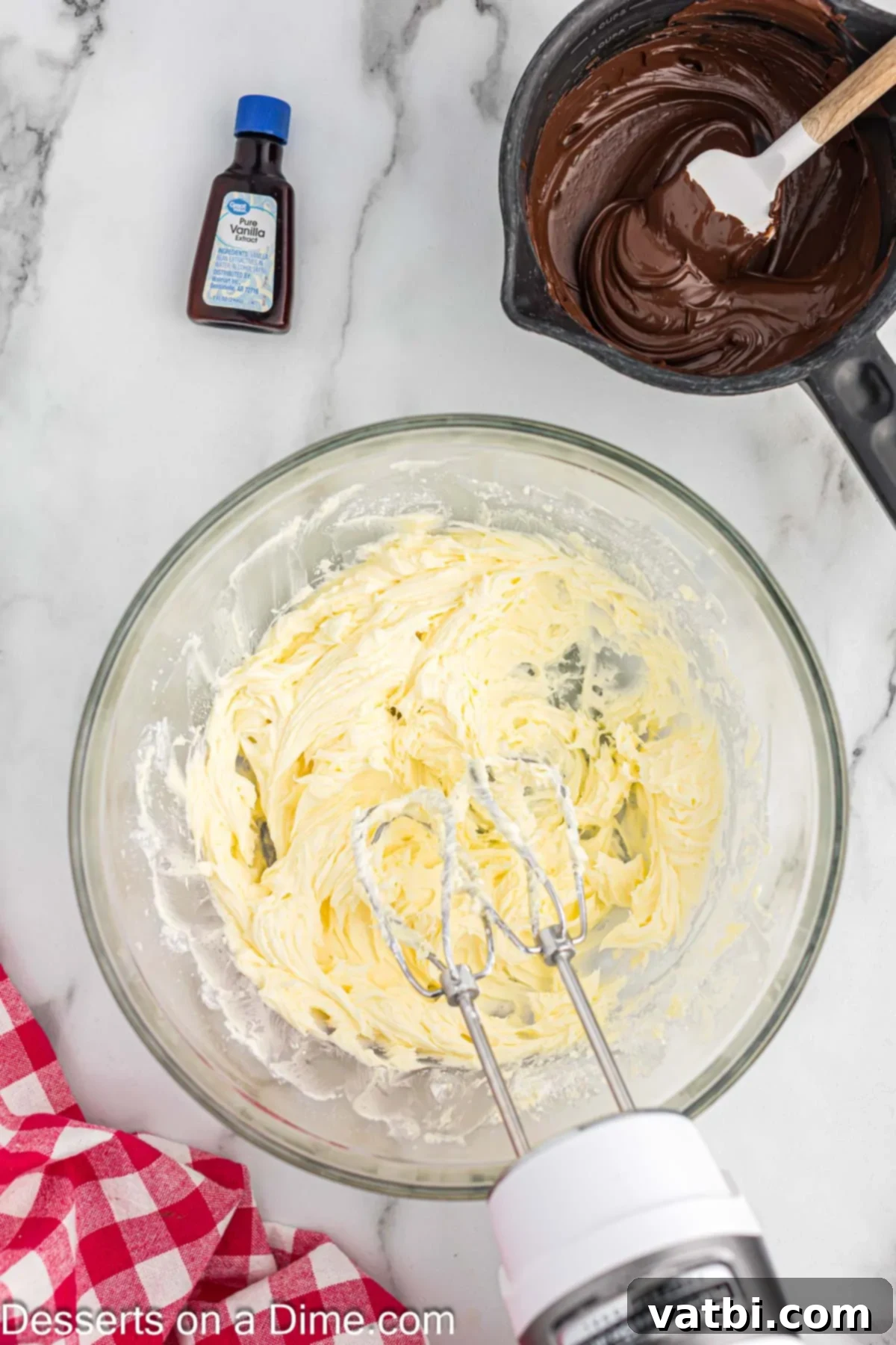 Crazy Simple Cake 10 Powdered sugar and creamed butter mixed together in a bowl, forming a smooth base for frosting.