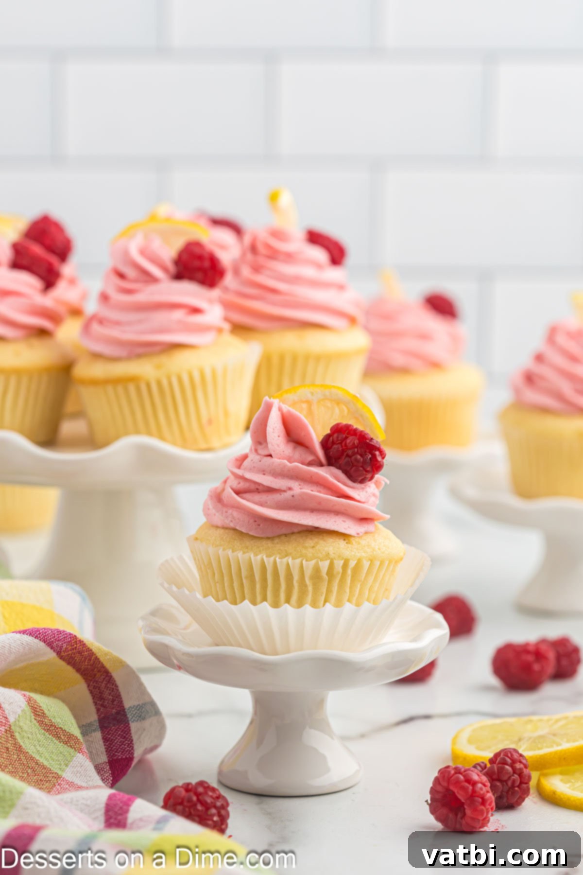 Sun-Kissed Lemon Raspberry Treats 2 Lemon raspberry cupcakes on platter.