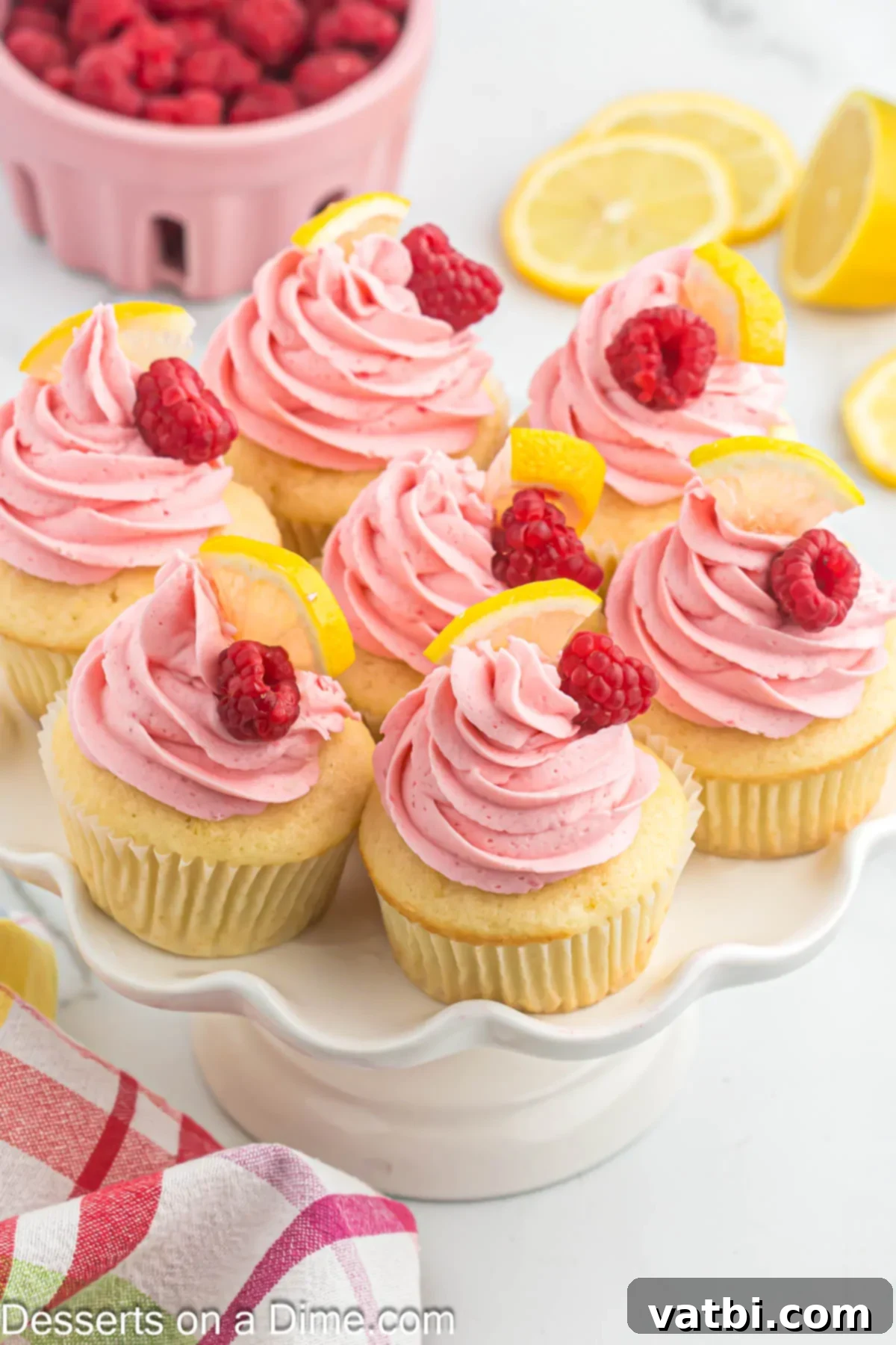 Sun-Kissed Lemon Raspberry Treats 12 Lemon raspberry cupcakes on platter.