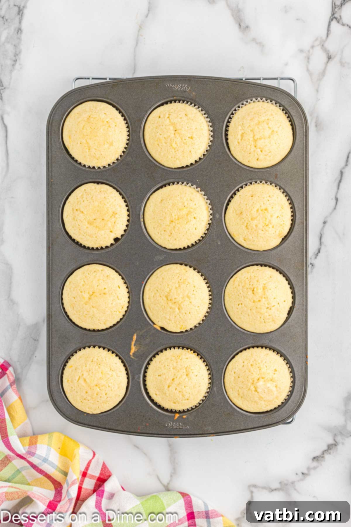 Sun-Kissed Lemon Raspberry Treats 7 Cupcakes baked and cooling in muffin tin.