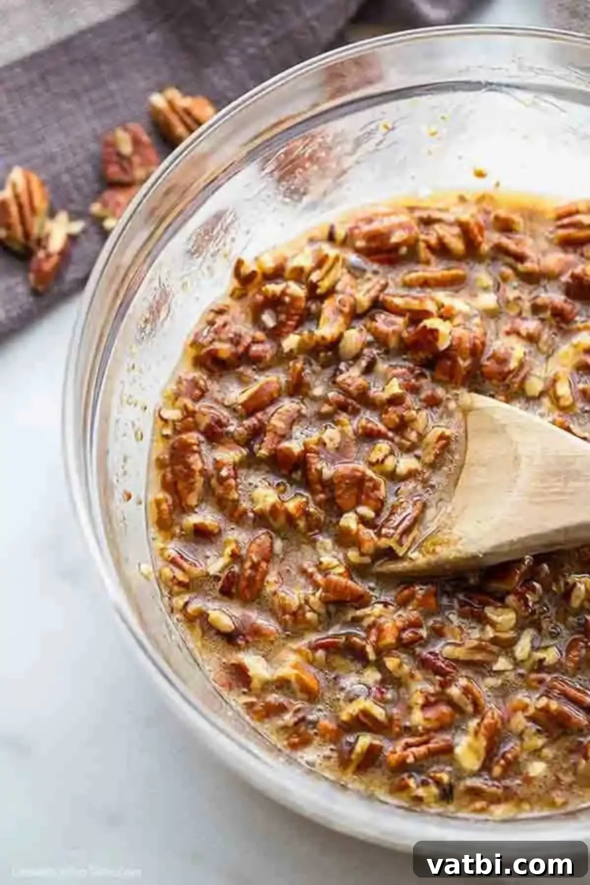 Pecan Pie Brownie Bliss 5 Pecan Pie filling combined in a bowl, showcasing the chopped pecans suspended in the gooey mixture.