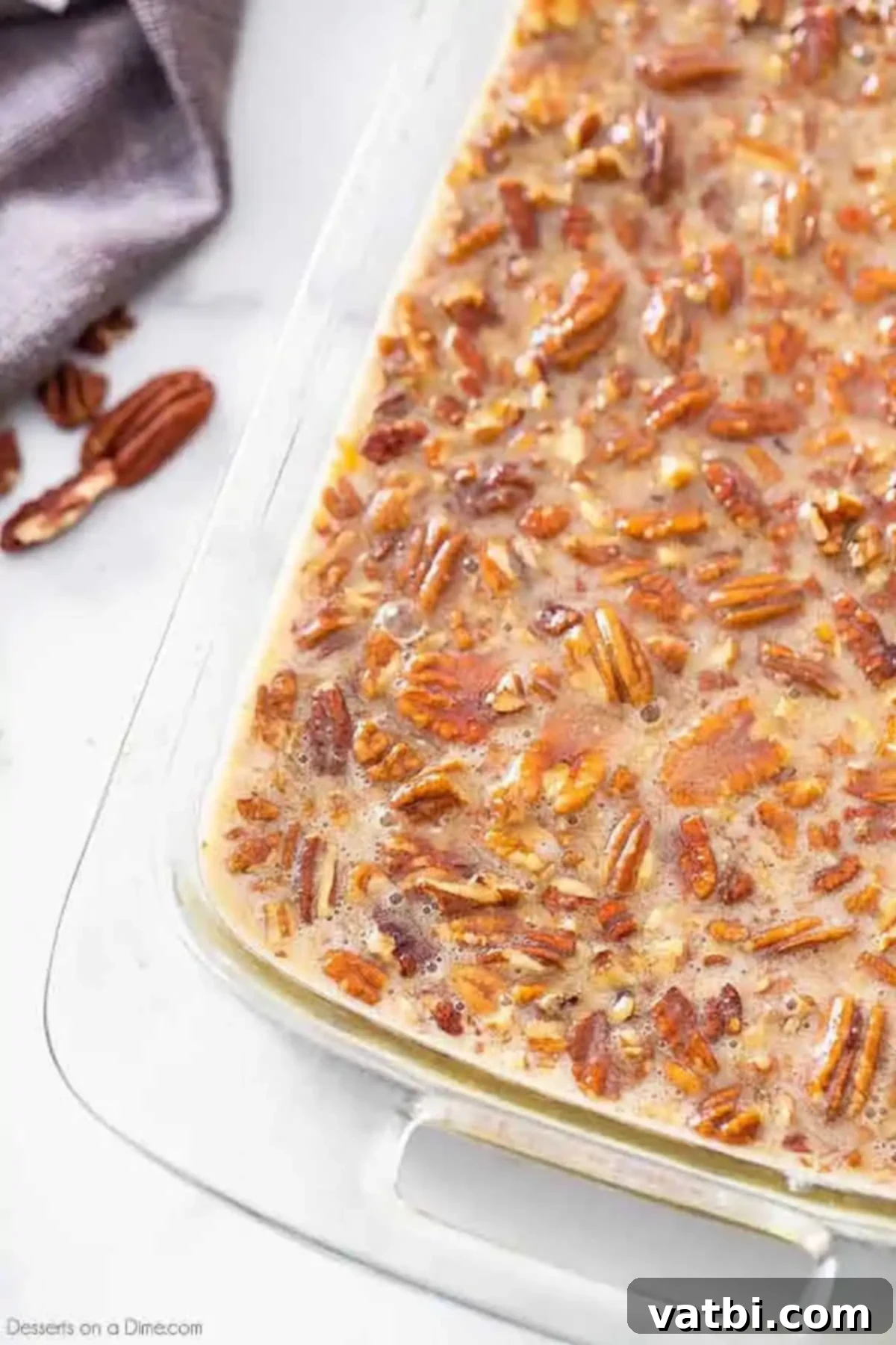 Pecan Pie Brownie Bliss 6 Pecan pie filling generously spread over the partially baked brownie batter in a baking dish.
