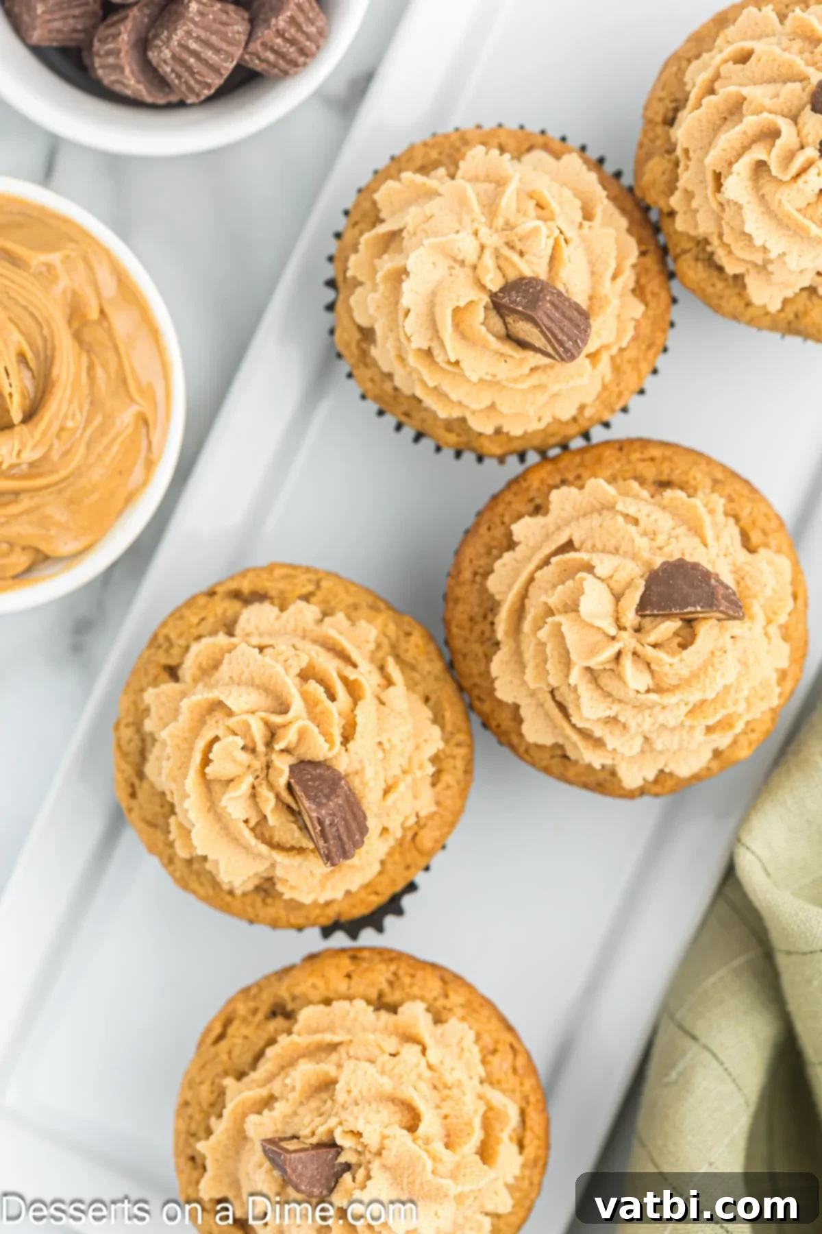 Heavenly Peanut Butter Cupcakes 10 Cupcakes topped with frosting and Reece's Cups.