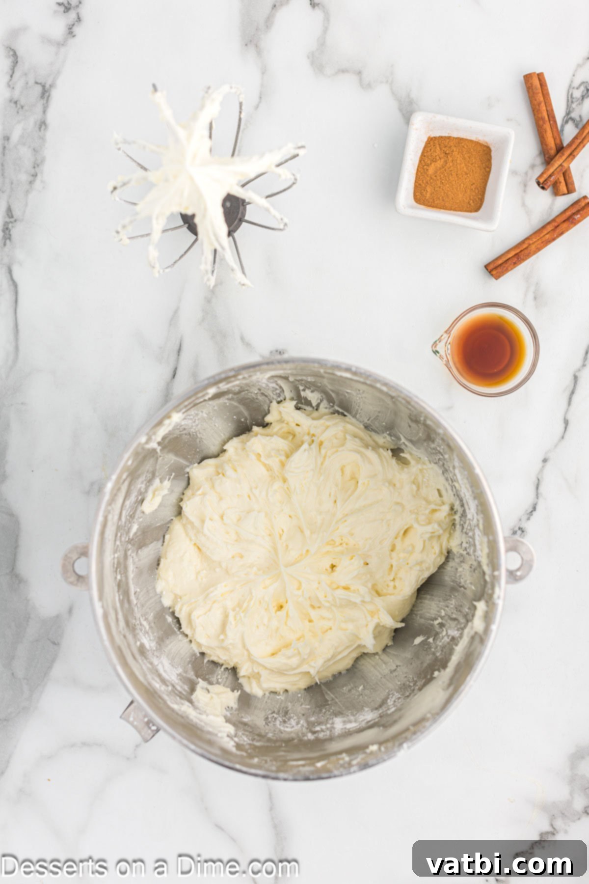 Irresistible Cinnamon Cream Cheese Frosting 5 A mixing bowl showing perfectly creamed butter and cream cheese, smooth and combined.