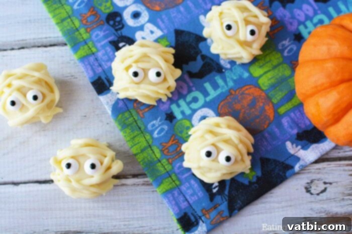 Halloween candy balls with eyes and a pumpkin.