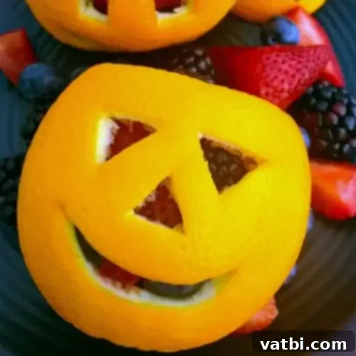 Oranges with faces carved into them.
