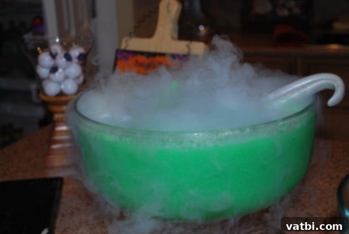 A bowl filled punch and a spoon.
