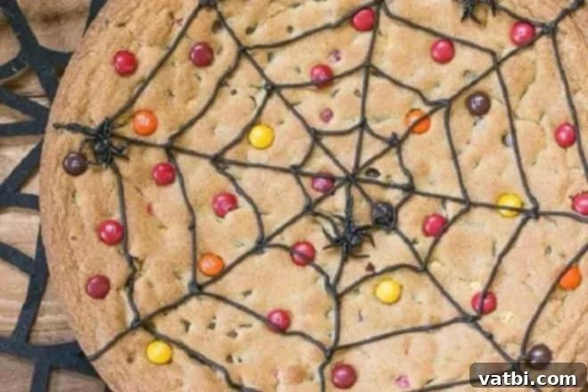 A spider web cookie with candy and candy corn.