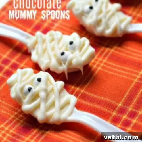 Chocolate mummy spoons on a tablecloth.