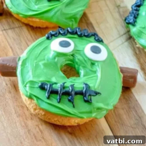 Three doughnuts decorated like halloween monsters.