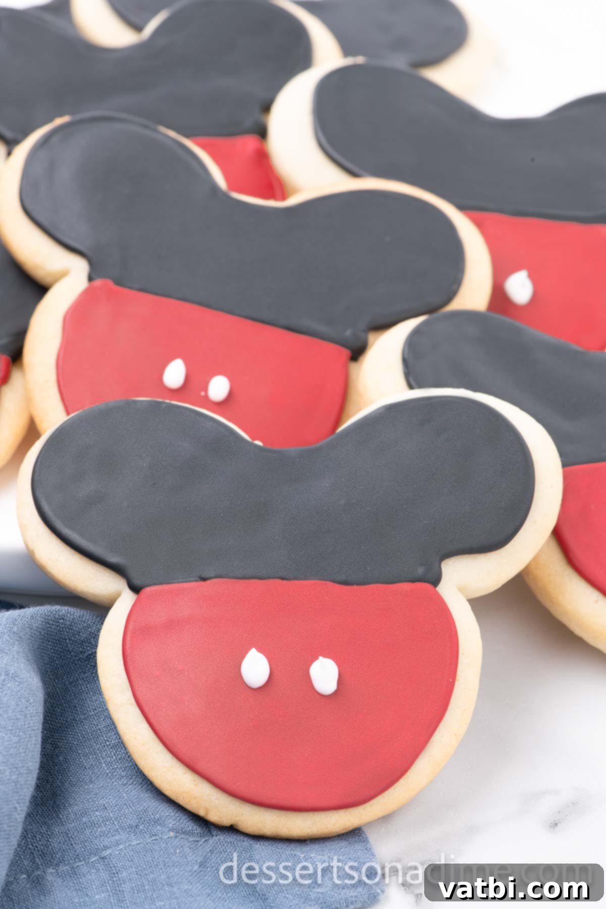 Magical Mickey Bakes 2 Mickey Mouse cookies on a platter, showcasing their iconic black, red, and white design.