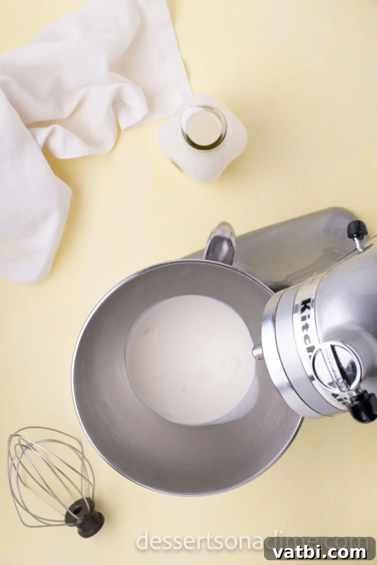 Your Own Scoop of Gelato Heaven 9 Heavy whipping cream being whipped in a stand mixer until stiff peaks form, creating a light and airy base.