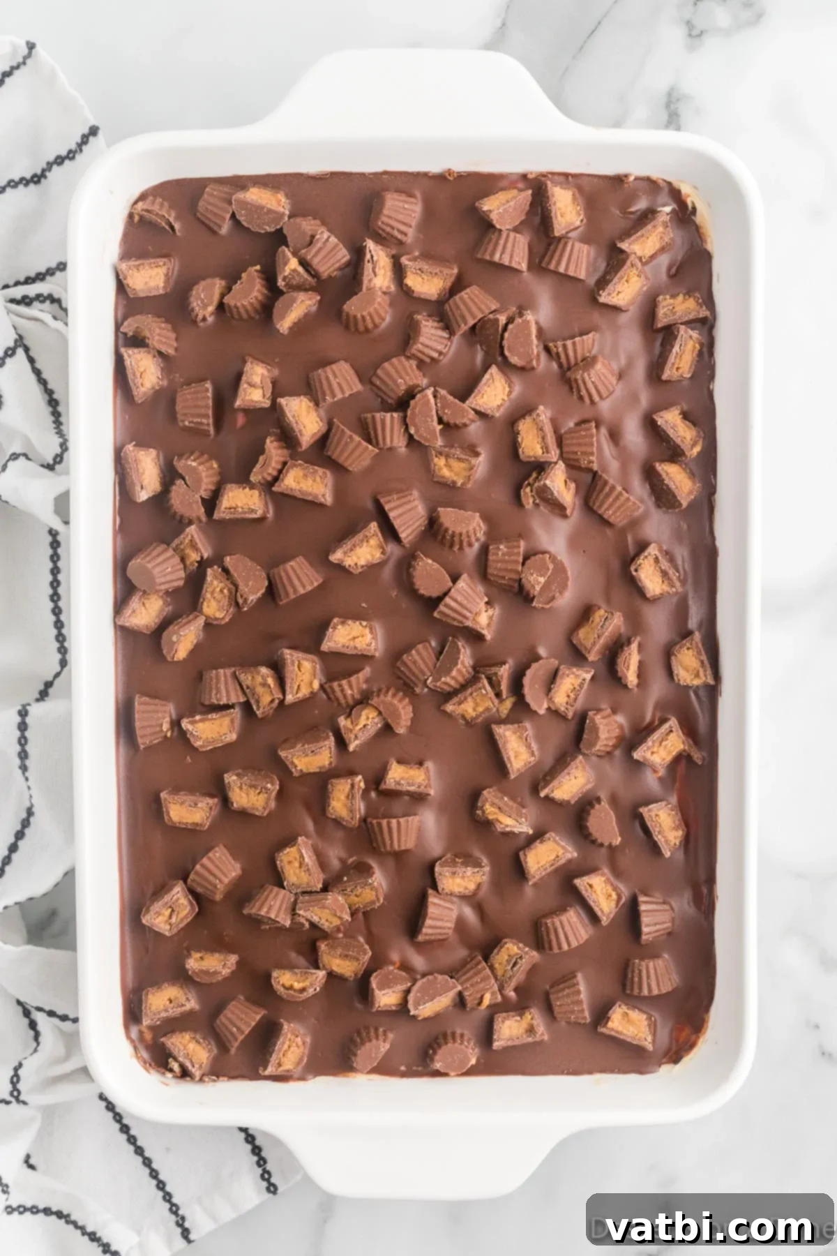 No-Bake Peanut Butter Bliss 11 Finely chopped Miniature Reese's Peanut Butter Cups sprinkled generously on top of the chocolate-covered icebox cake.
