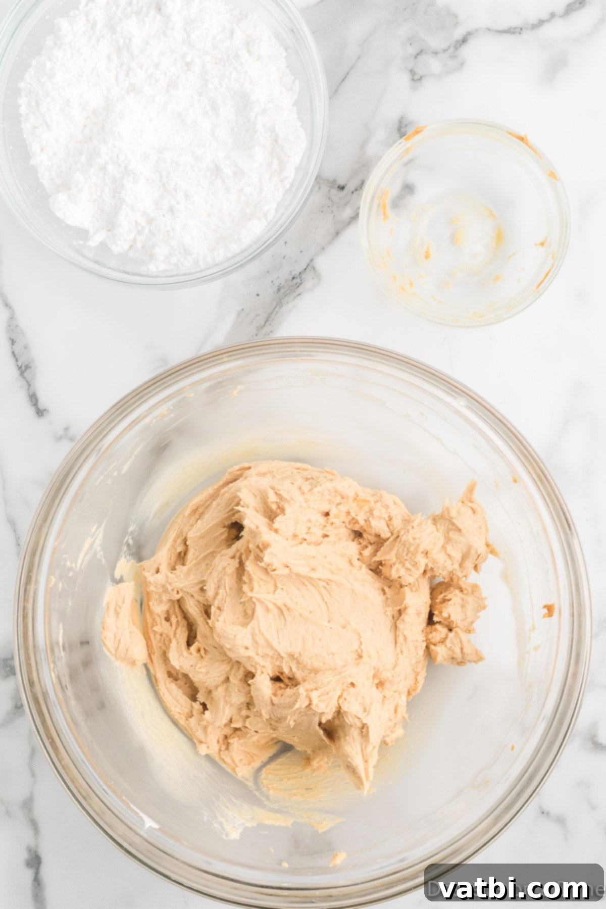No-Bake Peanut Butter Bliss 5 Powdered sugar being added to the creamy peanut butter and cream cheese mixture.