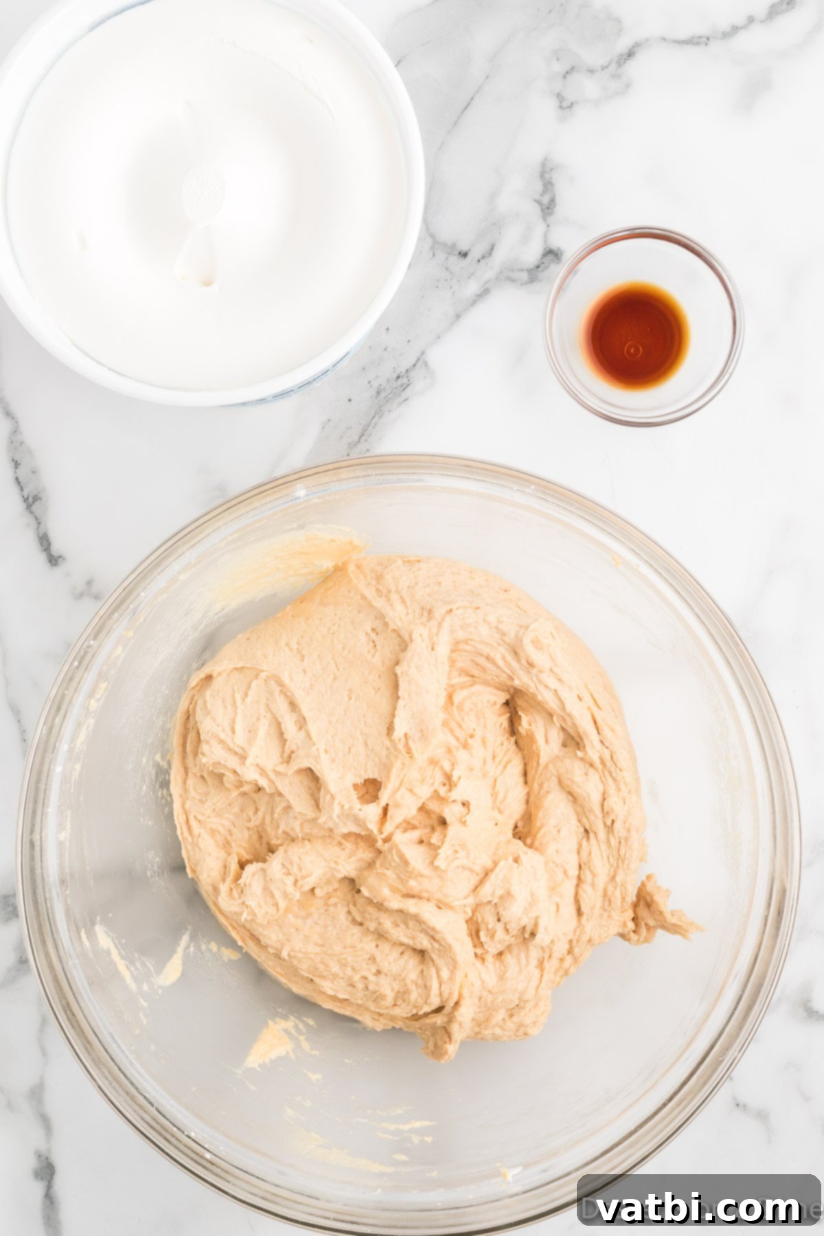 No-Bake Peanut Butter Bliss 6 Vanilla extract and thawed whipped topping being gently folded into the peanut butter mixture.