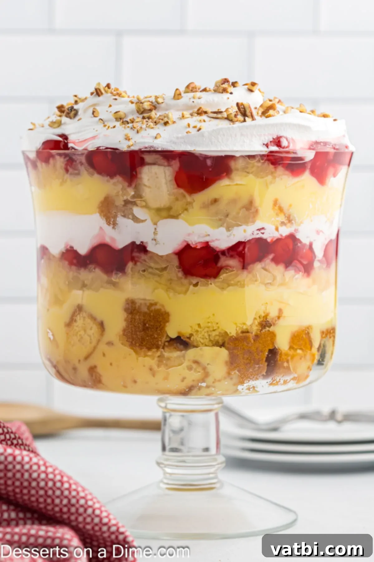 Party Punch Bowl Delight 9 A beautiful trifle dish filled with a completed Punch Bowl Cake, chilled and ready to be served, showing off its inviting layers.