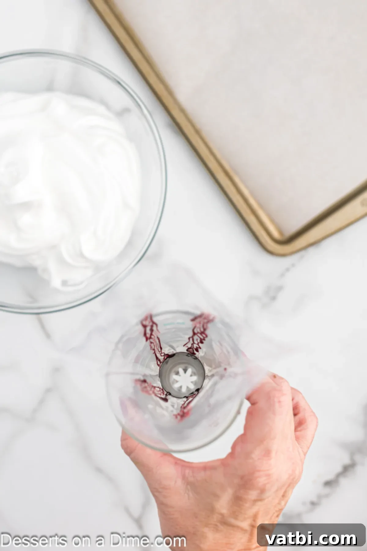 Crisp Peppermint Dream 6 A piping bag fitted with a star tip, showing red food coloring stripes painted inside, ready for meringue filling.