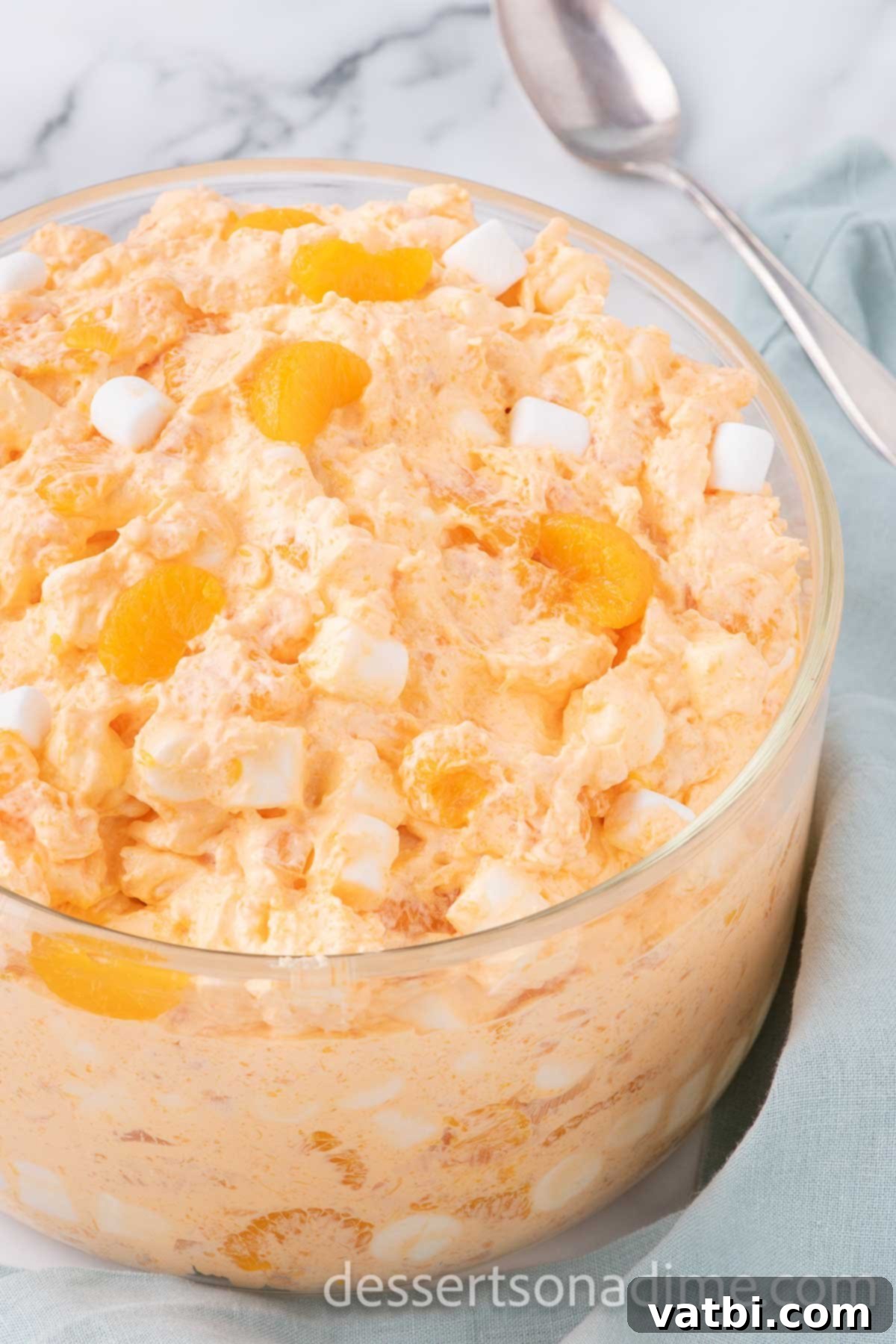 Tangerine Dream 8 A large bowl of prepared orange fluff, covered tightly with plastic wrap, ready for refrigeration.
