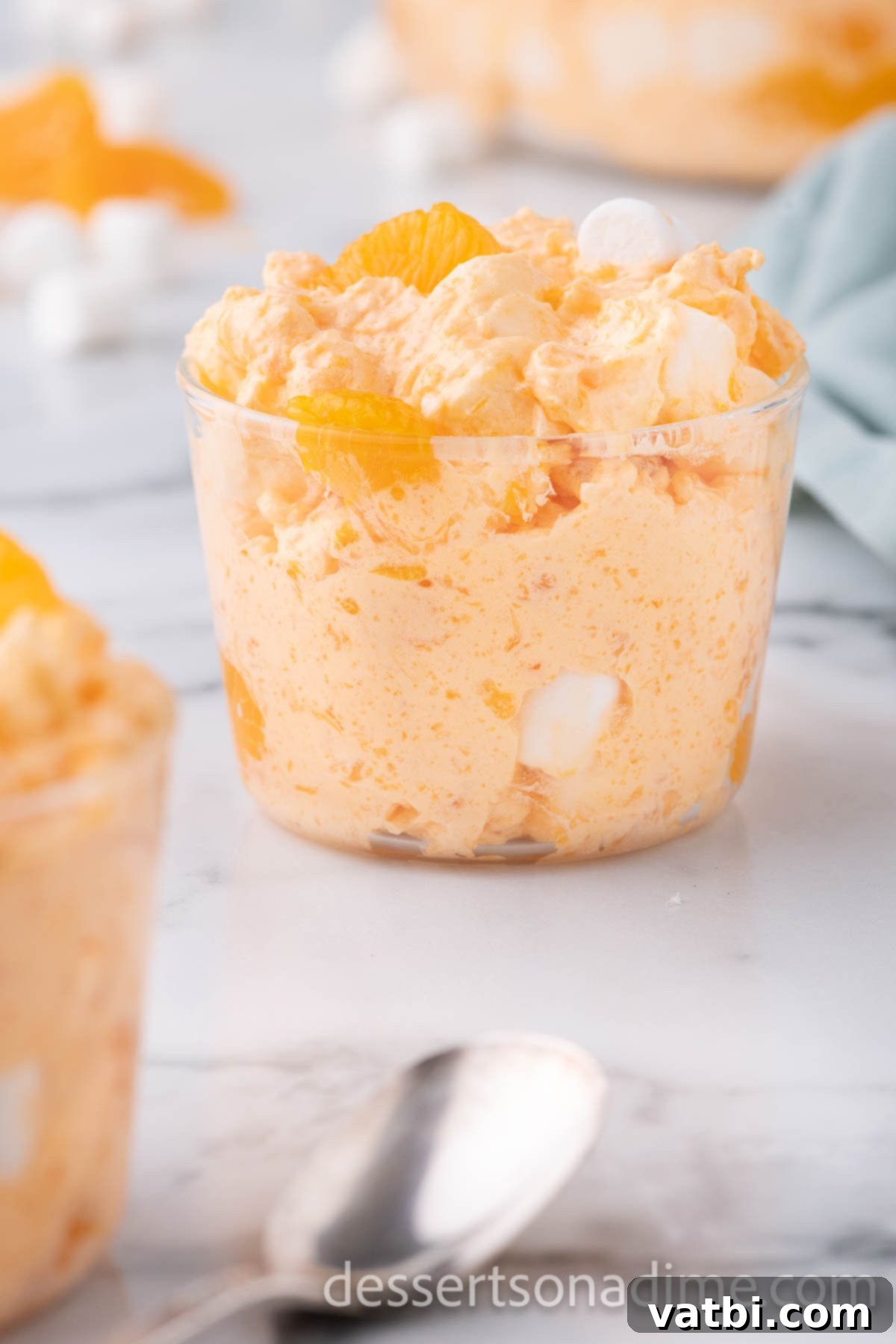 Tangerine Dream 10 A single cup of perfectly chilled orange fluff, garnished with an orange slice, awaiting enjoyment.